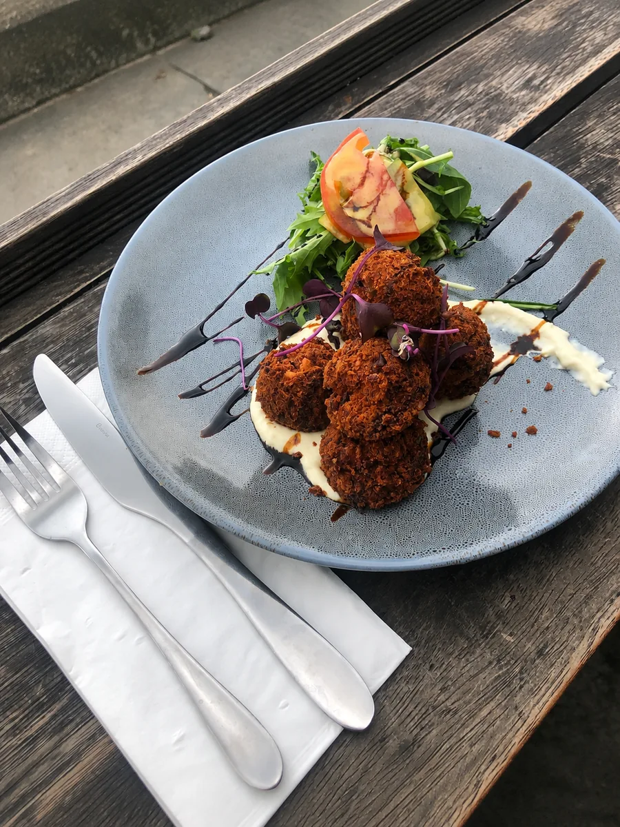 A plated savoury dish with salad at Scarborough Fare